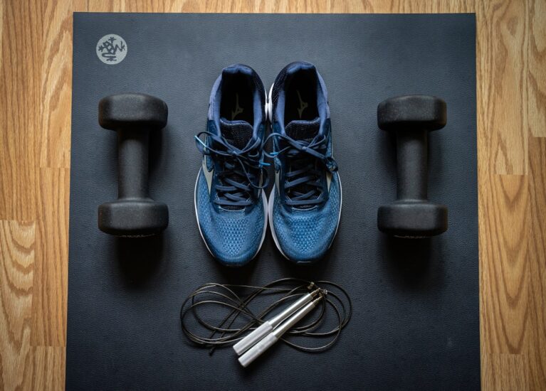 A person exercising at home with workout equipment, showcasing a variety of exercises in a cozy living space.