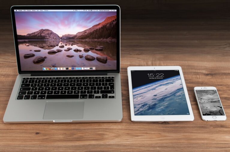 A close-up of a smartphone and laptop with charging cables, symbolizing battery life and technology.